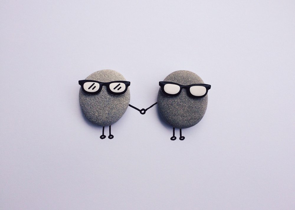 cute stones with glasses holding hands